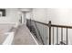 Hallway featuring neutral carpet and a decorative black metal banister at 3728 In Bloom Way, Auburn, GA 30011
