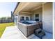 Outdoor patio showcasing a luxurious hot tub with seating and steps for easy access at 3728 In Bloom Way, Auburn, GA 30011