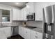 Bright kitchen offers white cabinets, stainless steel appliances, granite counters and tile backsplash at 3728 In Bloom Way, Auburn, GA 30011