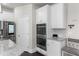 Modern kitchen showcases white cabinets, stainless steel appliances, and built-in double ovens at 3728 In Bloom Way, Auburn, GA 30011