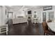 Open-concept view of living room, kitchen, and dining area showcasing hardwood floors at 3728 In Bloom Way, Auburn, GA 30011