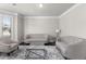 Cozy living room with tufted sofas, a glass coffee table, and a neutral color palette at 3728 In Bloom Way, Auburn, GA 30011