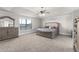 Spacious main bedroom with decorative trey ceiling, plush carpet, and luxurious furnishings at 3728 In Bloom Way, Auburn, GA 30011