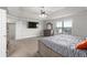 Inviting main bedroom featuring plush carpet, stylish furnishings, and a ceiling fan at 3728 In Bloom Way, Auburn, GA 30011