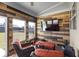 Cozy sunroom features wood paneling, comfortable seating, and a mounted television at 3728 In Bloom Way, Auburn, GA 30011