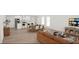 Spacious open concept living space with adjacent kitchen and dining areas and large screen tv at 95 Rome St, Temple, GA 30179
