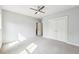 Large bedroom featuring neutral carpet, a ceiling fan, and a closet at 1998 Shalimar Ne Dr, Atlanta, GA 30345