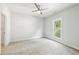 Spacious bedroom with neutral carpet, a ceiling fan, and a window view, offering a calming atmosphere at 1998 Shalimar Ne Dr, Atlanta, GA 30345