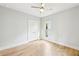 Bedroom with light grey walls, hardwood floors, double door closet, and a window at 1998 Shalimar Ne Dr, Atlanta, GA 30345
