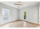 Bedroom featuring light grey walls, hardwood floors, and a door leading to an outdoor balcony at 1998 Shalimar Ne Dr, Atlanta, GA 30345