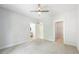 Bright bedroom featuring neutral colored carpet, a ceiling fan, and multiple doorways at 1998 Shalimar Ne Dr, Atlanta, GA 30345