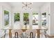 Well-lit dining room with a modern chandelier, hardwood floors, and large windows at 1998 Shalimar Ne Dr, Atlanta, GA 30345