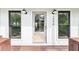 Front entrance featuring a glass door, black window trim, and exterior sconce lighting at 1998 Shalimar Ne Dr, Atlanta, GA 30345