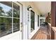 Inviting front porch featuring a wooden deck, craftsman door, and modern exterior lighting at 1998 Shalimar Ne Dr, Atlanta, GA 30345