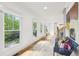 Hallway with light hardwood floors, view of outdoor patio, and modern artwork at 1998 Shalimar Ne Dr, Atlanta, GA 30345