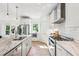 Bright kitchen featuring stainless steel appliances, white cabinets, marble countertops, and hardwood floors at 1998 Shalimar Ne Dr, Atlanta, GA 30345