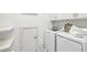 Clean laundry room featuring washer and dryer, storage shelves, and decorative tile flooring at 1998 Shalimar Ne Dr, Atlanta, GA 30345