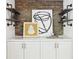 Living room built-ins with exposed brick, floating shelves, white cabinets, and modern art at 1998 Shalimar Ne Dr, Atlanta, GA 30345