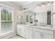 Elegant main bathroom featuring marble-tiled floor, vanity with double sinks and large mirror at 1998 Shalimar Ne Dr, Atlanta, GA 30345