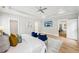 Bright main bedroom with wood floors, TV, ceiling fan, blue chairs and doorway to main bath at 1998 Shalimar Ne Dr, Atlanta, GA 30345