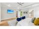 Bright main bedroom with wood floors, TV, ceiling fan, blue chairs and walk in closet at 1998 Shalimar Ne Dr, Atlanta, GA 30345