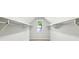 Bright walk-in closet with window and built-in shelves and rods at 1998 Shalimar Ne Dr, Atlanta, GA 30345