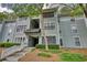 Three-story residential building with light gray siding and stairway access at 211 Summit North Drive Ne, Atlanta, GA 30324