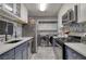 Modern kitchen with stainless steel appliances, navy lower cabinets, and mosaic backsplash at 211 Summit North Drive Ne, Atlanta, GA 30324