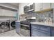 Well-equipped kitchen with stainless steel appliances, stylish backsplash, and navy and white cabinets at 211 Summit North Drive Ne, Atlanta, GA 30324