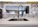 Close-up of kitchen sink with a modern faucet and mosaic backsplash, offering a stylish touch at 211 Summit North Drive Ne, Atlanta, GA 30324