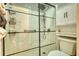 Shower featuring white tiled walls, glass door and black hardware at 211 Summit North Drive Ne, Atlanta, GA 30324