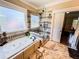 Luxurious bathroom with a soaking tub, glass enclosed shower, and decorative tile accents at 2319 Lochinver Ln, Conyers, GA 30094