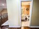 Bathroom view from hallway shows tile flooring, vanity and toilet with decorator mirror on wall at 2319 Lochinver Ln, Conyers, GA 30094