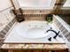 A luxurious soaking tub with stylish fixtures and decorative tile surround offers a relaxing spa-like experience at 2319 Lochinver Ln, Conyers, GA 30094