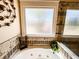A luxurious soaking tub with stylish fixtures and decorative tile surround offers a relaxing spa-like experience at 2319 Lochinver Ln, Conyers, GA 30094