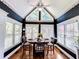 This charming breakfast nook features many windows, vaulted ceiling, and a modern ceiling fan at 2319 Lochinver Ln, Conyers, GA 30094