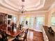 Open dining room layout with hardwood floors, chandelier, and natural light at 2319 Lochinver Ln, Conyers, GA 30094