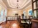 Well-lit dining room boasting beautiful floors, a modern buffet, and an ornate chandelier at 2319 Lochinver Ln, Conyers, GA 30094