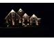 Charming single-Gathering home with brick facade illuminated by landscape lighting at night at 2319 Lochinver Ln, Conyers, GA 30094