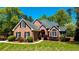 Beautiful brick home with a well-maintained front yard and charming architectural details at 2319 Lochinver Ln, Conyers, GA 30094