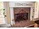 Close-up of a charming brick fireplace with decorative ironwork and a white mantel at 2319 Lochinver Ln, Conyers, GA 30094
