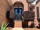 Elegant black double doors with decorative ironwork and manicured bushes at 2319 Lochinver Ln, Conyers, GA 30094