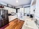 Open kitchen with white cabinets, stainless steel appliances, granite countertops, and modern backsplash at 2319 Lochinver Ln, Conyers, GA 30094
