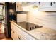Updated kitchen featuring sleek countertops, stainless steel microwave and cooktop, and custom cabinetry at 2319 Lochinver Ln, Conyers, GA 30094