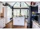 Bright kitchen featuring hardwood floors, a center island, stainless steel refrigerator and plenty of natural light at 2319 Lochinver Ln, Conyers, GA 30094