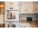 Kitchen with double ovens, granite countertops, subway tile backsplash, and white cabinets at 2319 Lochinver Ln, Conyers, GA 30094