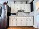 Bright kitchen featuring stainless steel appliances, granite countertops, white cabinets, and wood floors at 2319 Lochinver Ln, Conyers, GA 30094