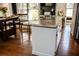 Kitchen island with granite countertops and white cabinets, overlooking hardwood floors at 2319 Lochinver Ln, Conyers, GA 30094