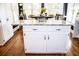 Kitchen island with white cabinets and granite countertops, great for entertaining at 2319 Lochinver Ln, Conyers, GA 30094