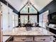 Bright eat-in kitchen boasts a large island with granite countertop and vaulted ceiling with large picturesque windows at 2319 Lochinver Ln, Conyers, GA 30094
